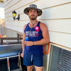 Man wearing smoke meat not meth shirt